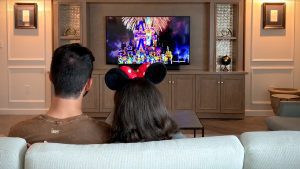 Couple watching fireworks in a Walt Disney World Resort hotel room
